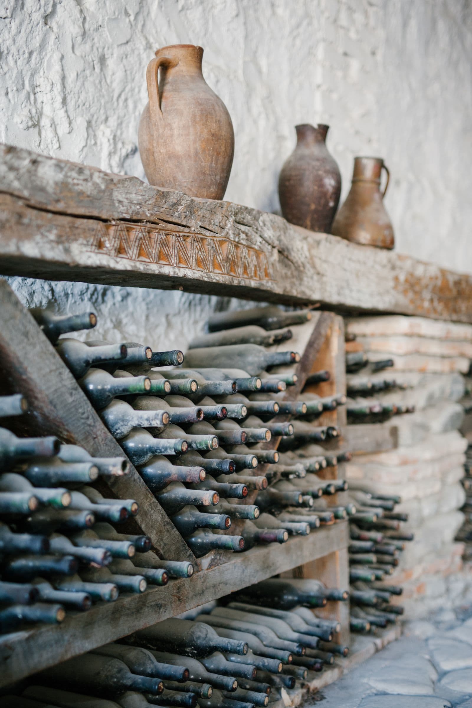 Amber wine poured from a clay qvevri in a Kakhetian cellar