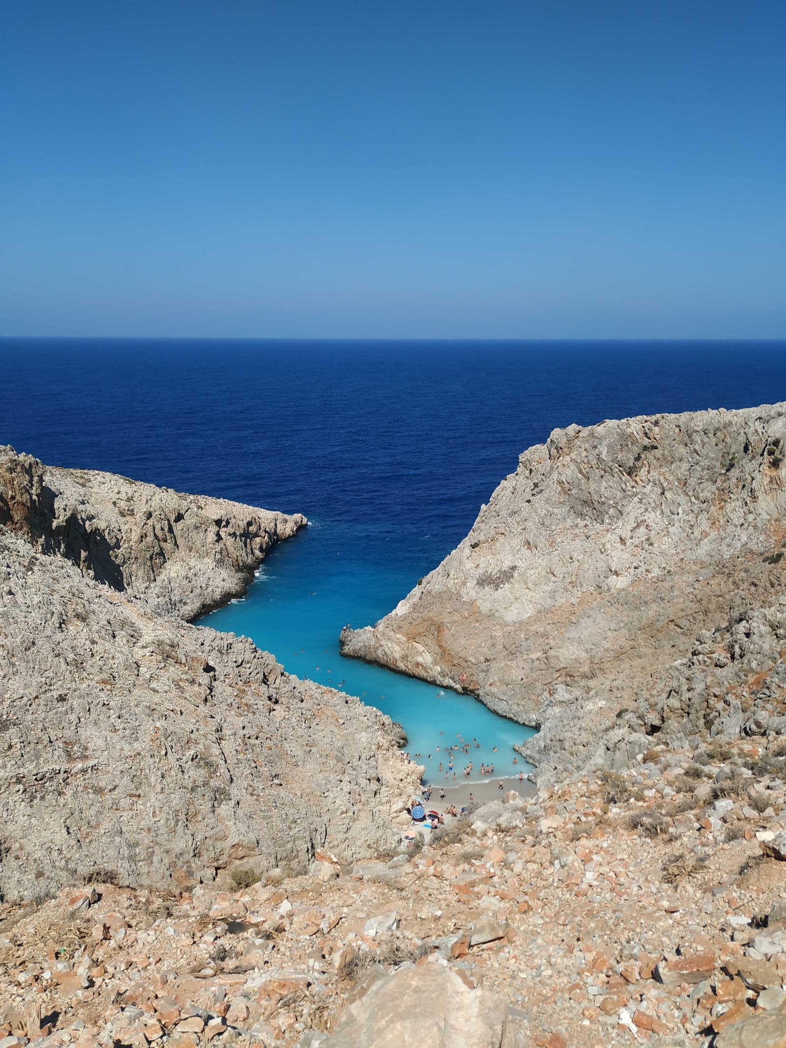 Sandy beach and clear turquoise sea on a summer day in Greece