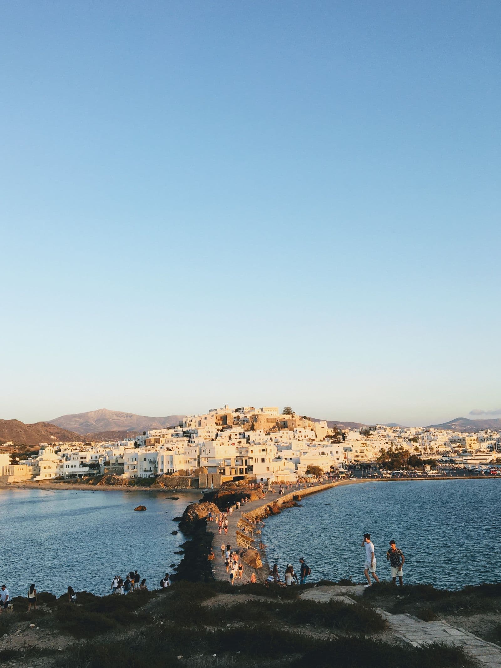 A Greek island ferry approaching a whitewashed port