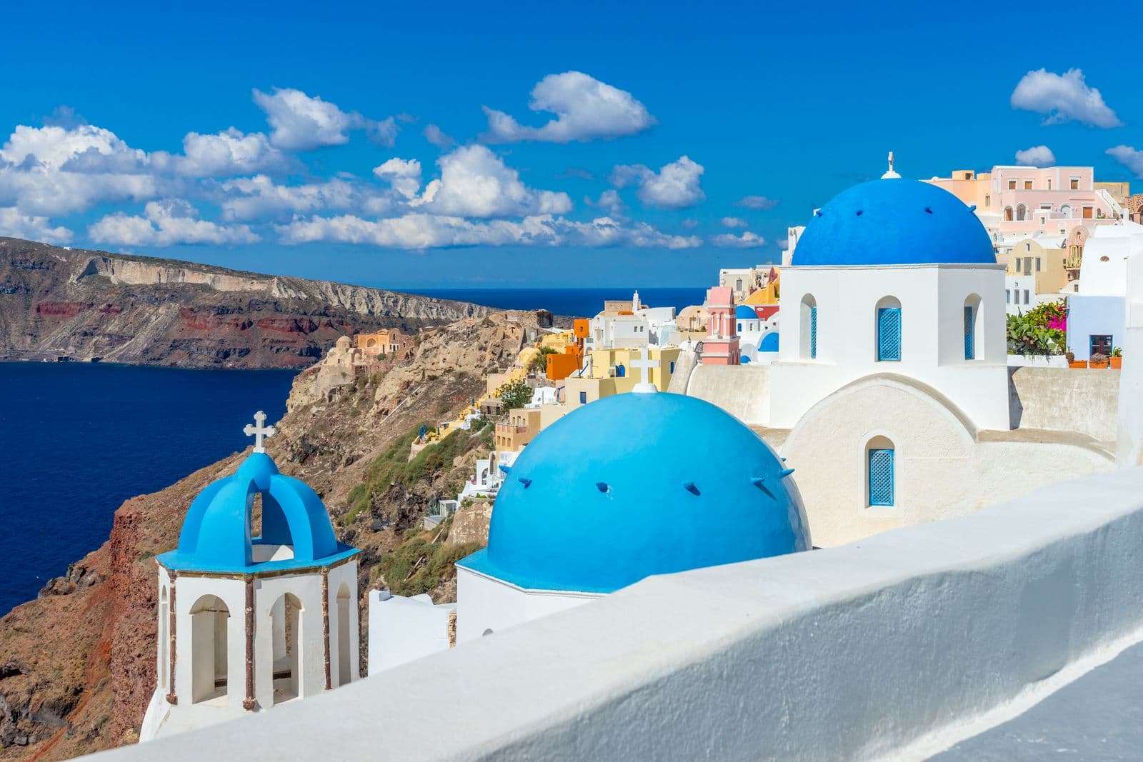Whitewashed cliffside village of Oia above the Santorini caldera at dusk