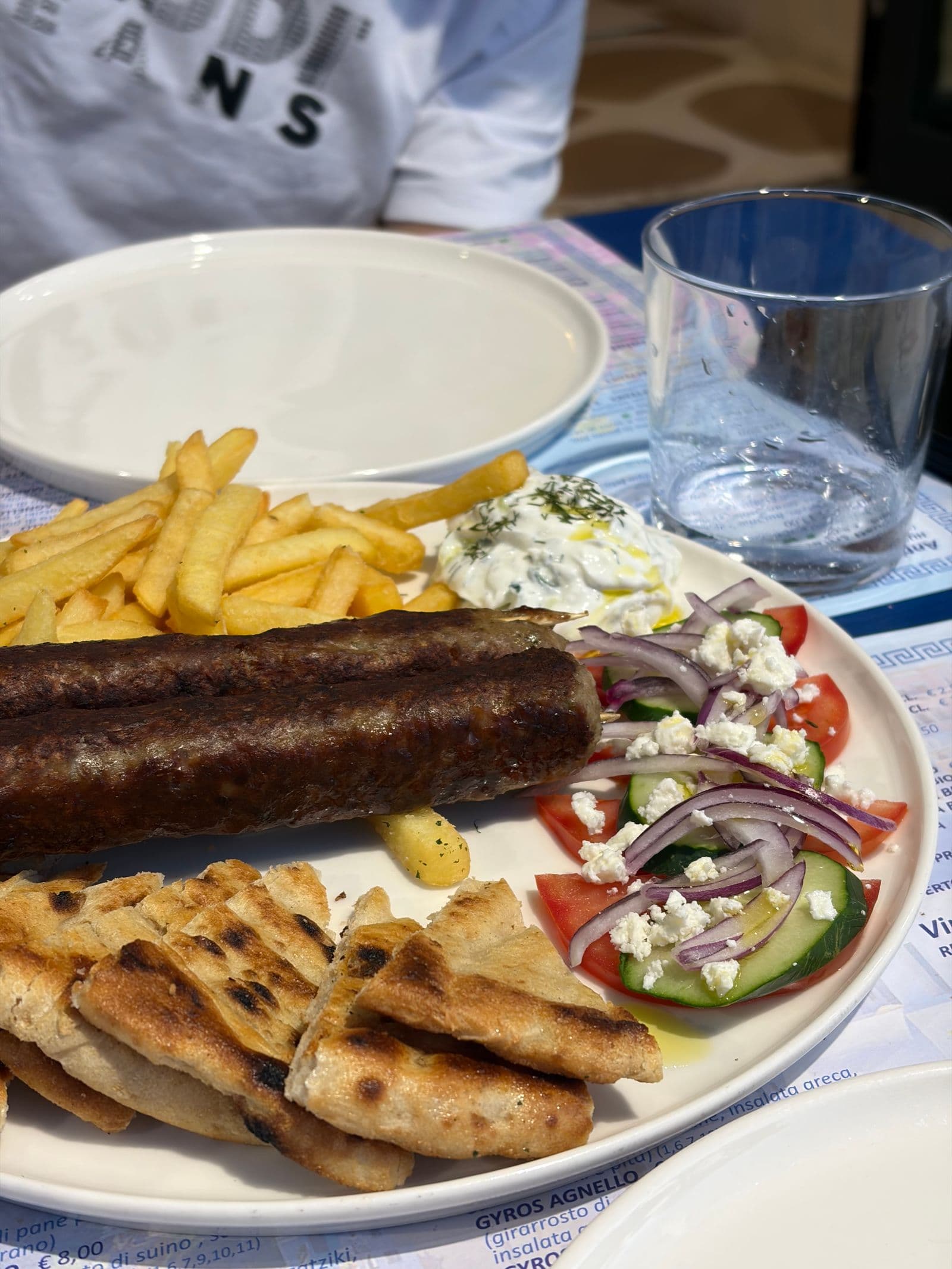 A Cretan taverna table under a vine
